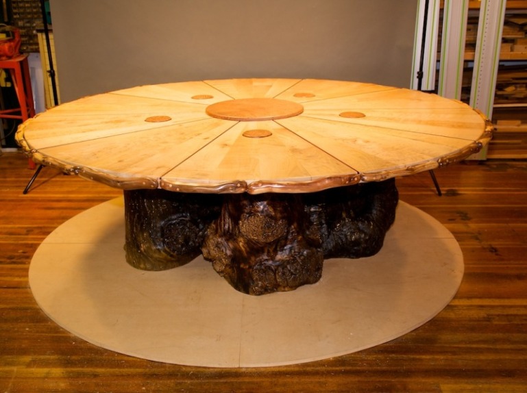8' diameter conference table in maple flame redwood burl  bloodwood on maple burl tree trunk legs in the studio awaiting delivery.jpg