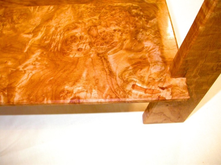 curved table in figured maple and bubinga with walnut accents detail of bottom burl.jpg